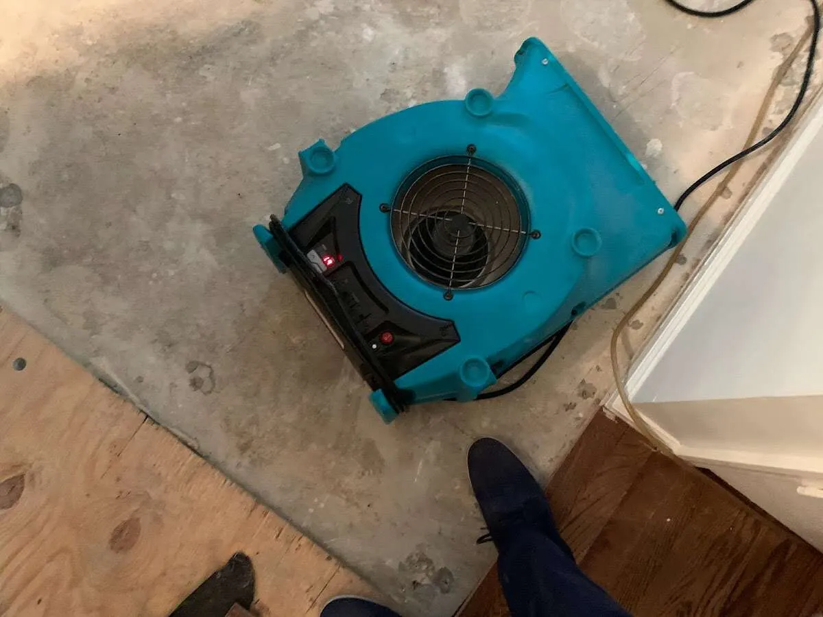 Air mover drying subfloor during Commercial Water Damage Restoration in Ham Lake